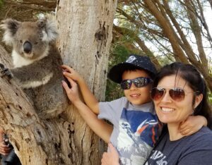 Erika Bud and son petting koala in Australia